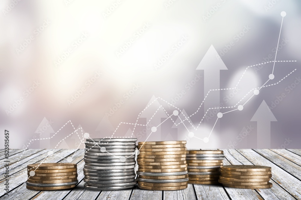 stack of coins with trading chart in financial concepts and financial investment business stock grow