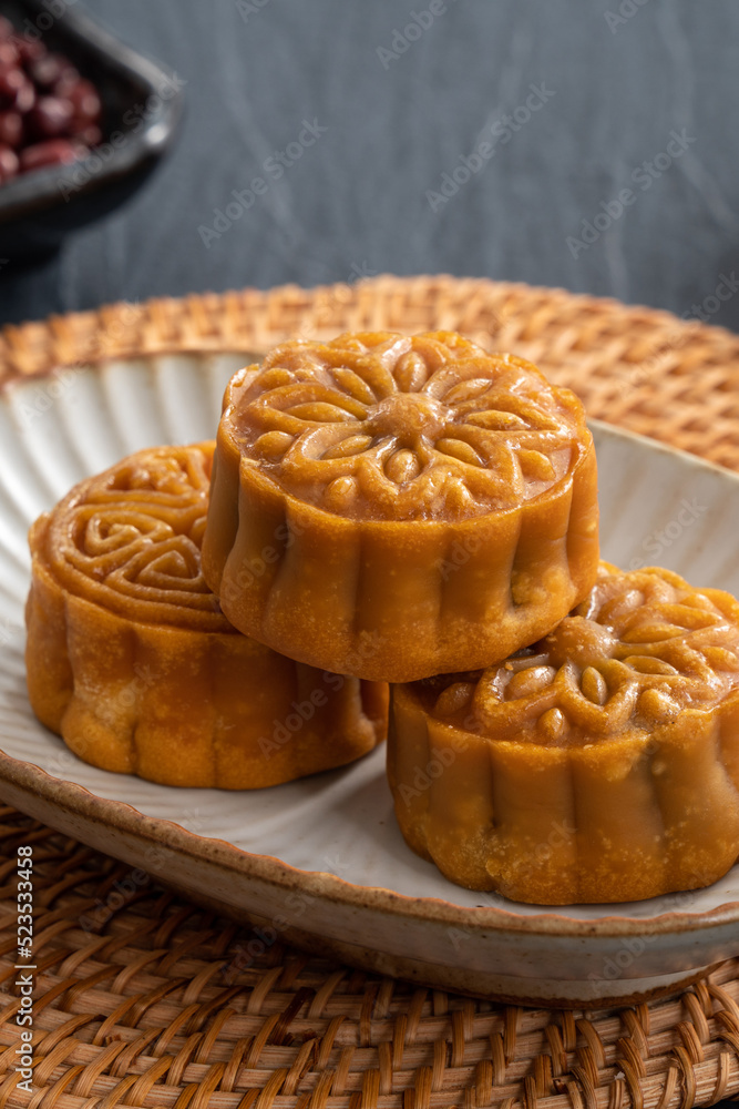 Delicious Cantonese moon cake for Mid-Autumn Festival food mooncake on blue table background.