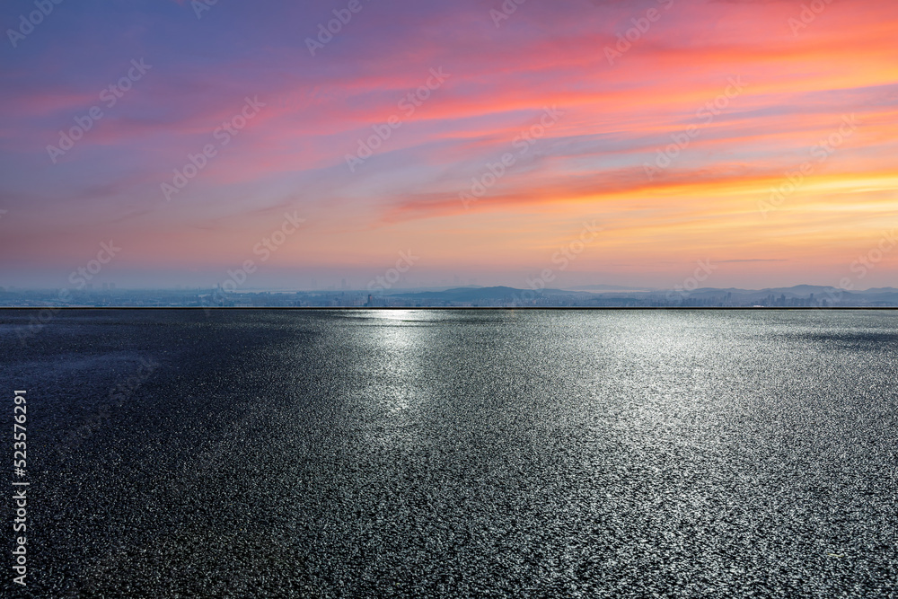 Asphalt road ground with colorful sky clouds at sunset. high angle view.