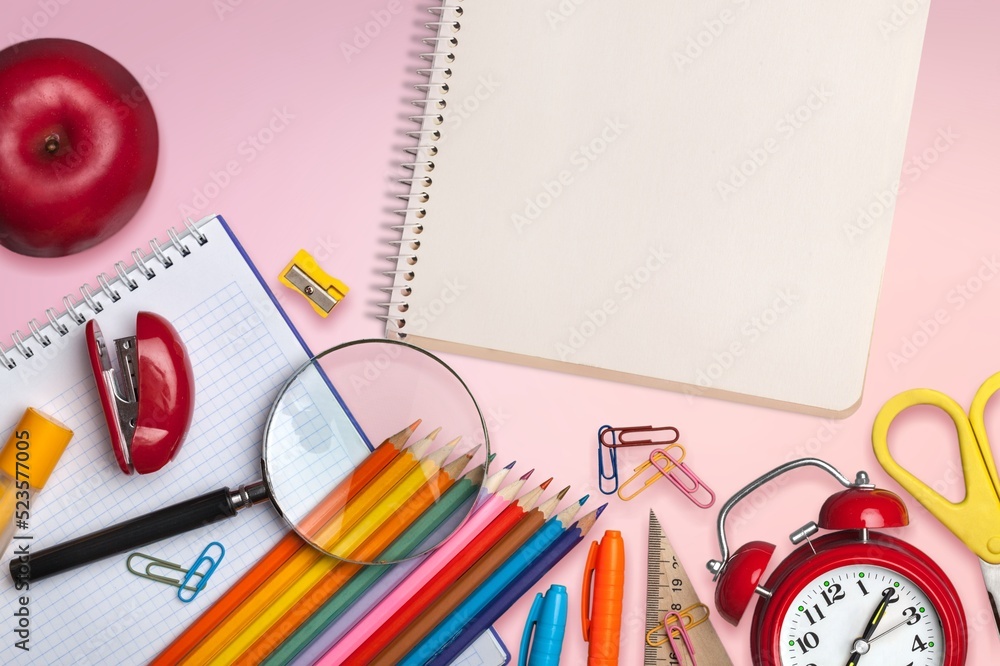 Back to school concept. Notepads pens erasers on  background