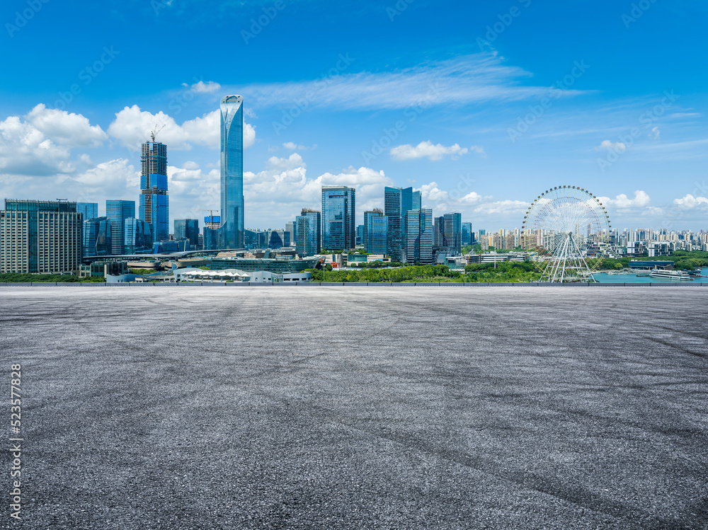 Asphalt road and city skyline with modern building in Suzhou, China.