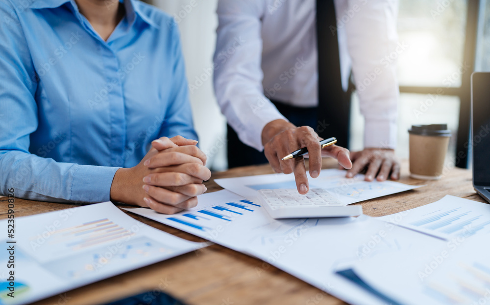 business partnership coworkers analysis strategy with discussing a financial planning graph and comp