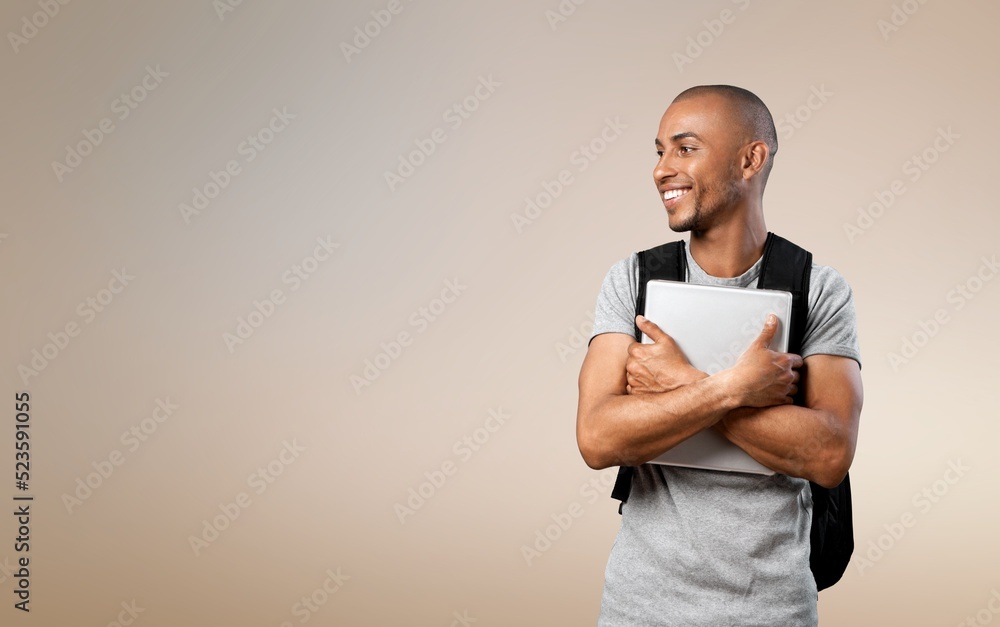 Happy school, college or university student with backpack. Cheerful handsome young man smiling