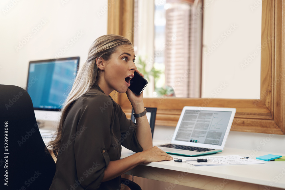 Surprised, shocked and excited young businesswoman gossiping and listening to fake news on a phone c