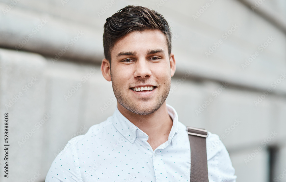 Face of a happy, smiling and professional business man, entrepreneur or employee standing in the cit