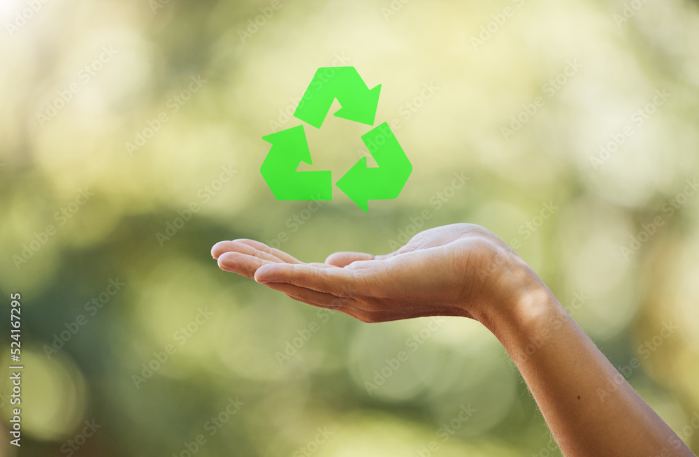 Hand, closeup recycle sign isolated with bokeh effect background. Zero waste, ecology and environmen