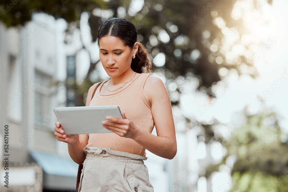 Reading, checking or browsing social media on tablet while out commuting through city and looking fo