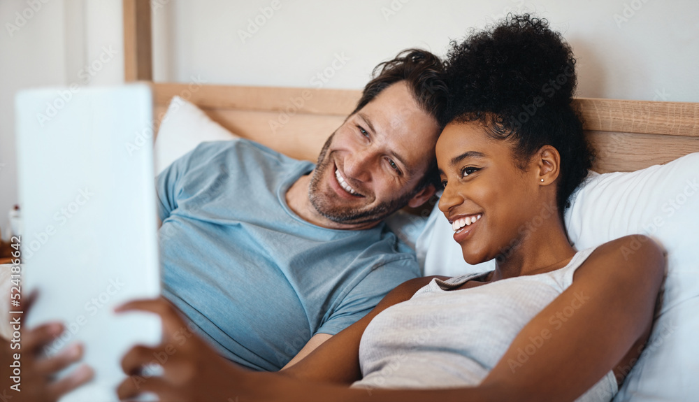 Happy, relax and carefree interracial couple on digital tablet smiling and taking a selfie in bed. H