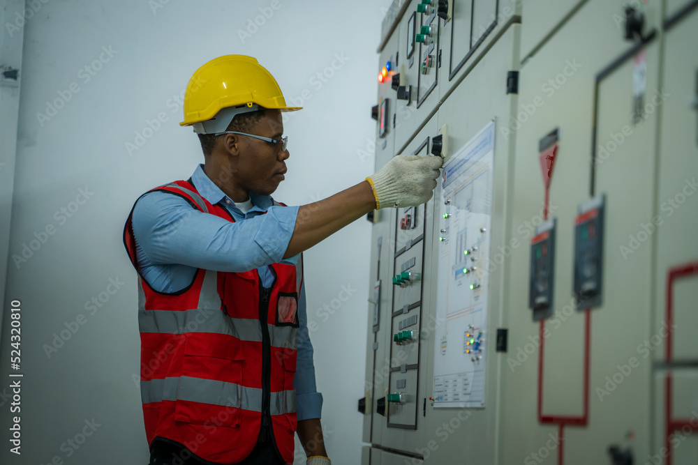 Engineer working in electrical control room,operator station network in industry factory,Switchgear.