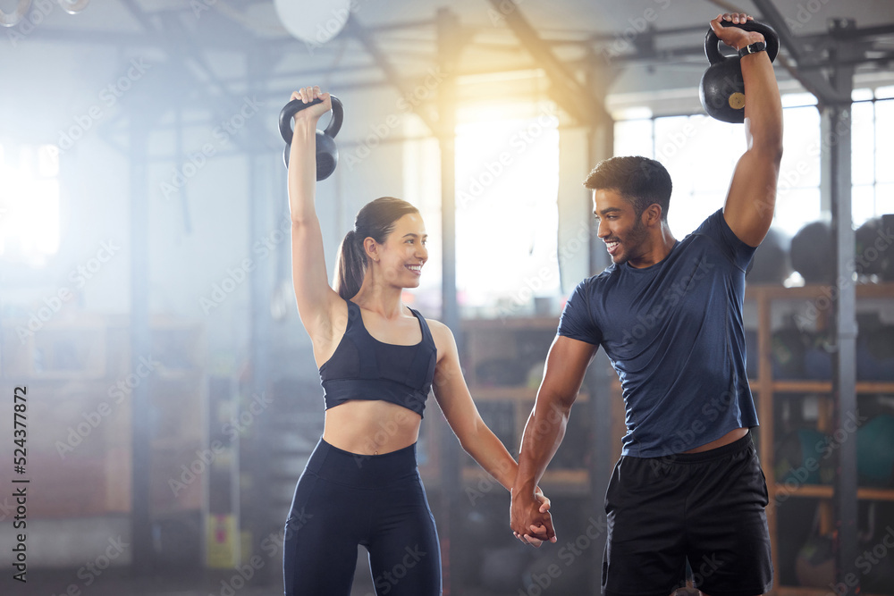 Fitness, kettlebell and couple in a workout exercise and holding hands in a gym. Fit sports people i