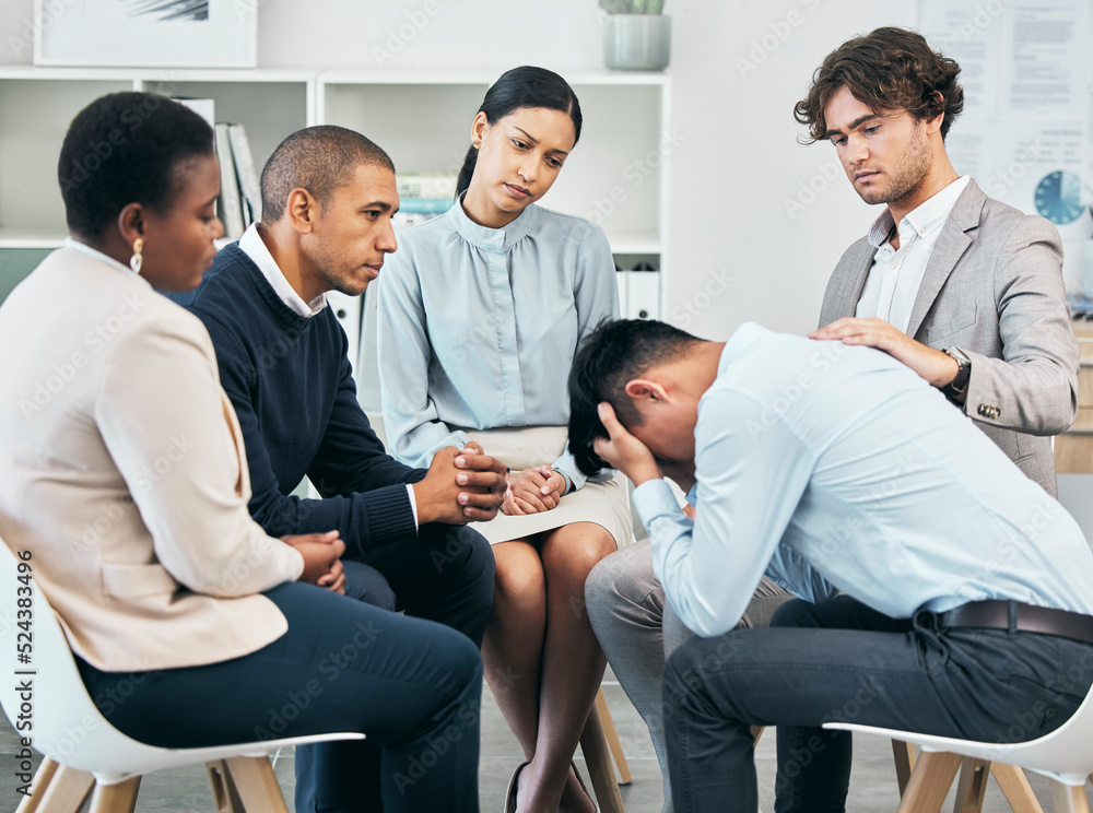 Depression, support and unity by colleagues comforting male after getting bad news at work. Communit