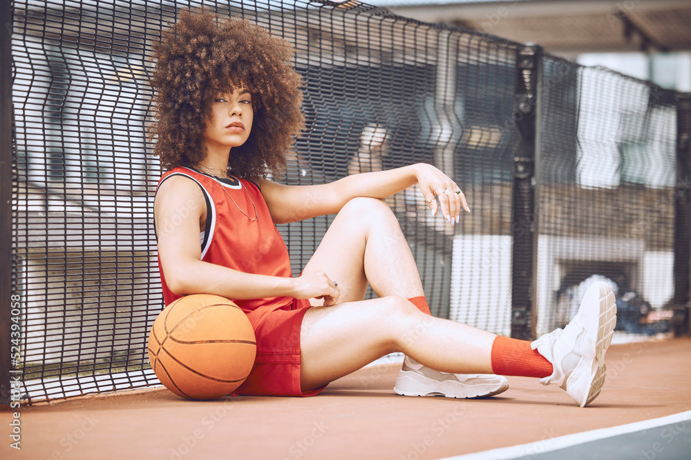 Relaxed, attitude and cool female basketball player relaxing outdoors on a court. Portrait of a tren