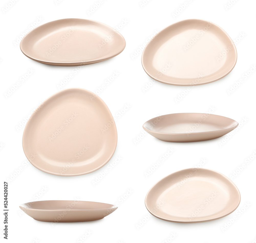 Set of beige ceramic plates isolated on white