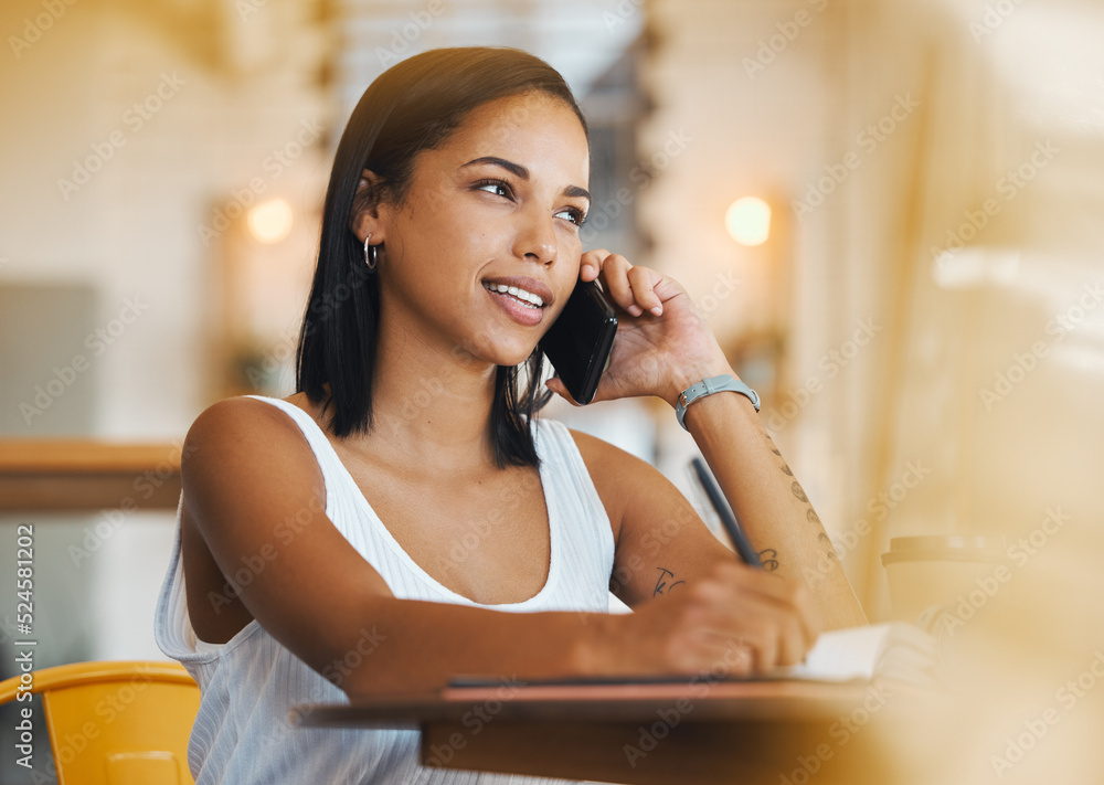 Freelance worker working in a coffee shop talking on a phone call about a growth strategy. Young fem