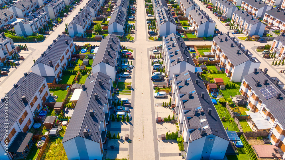 An aerial view of the houses and streets. A residential area in the suburbs. Houses and private yard