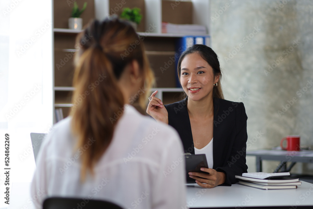 Female manager in office discussing and interviewing job applicant for new employees.