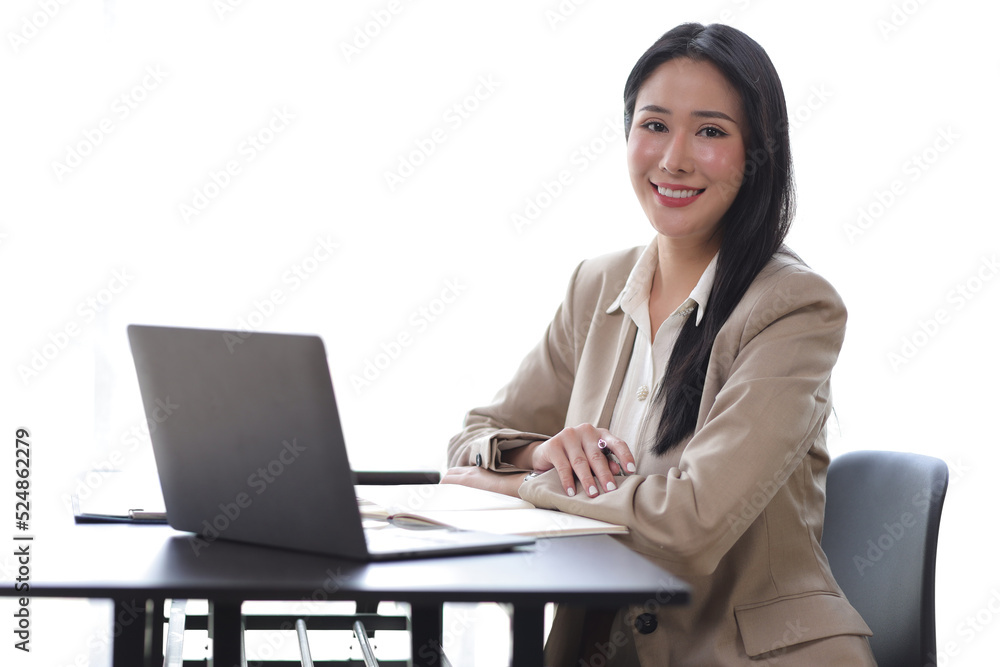 Portrait of a charming beautiful young business woman in the office working on a laptop and financia