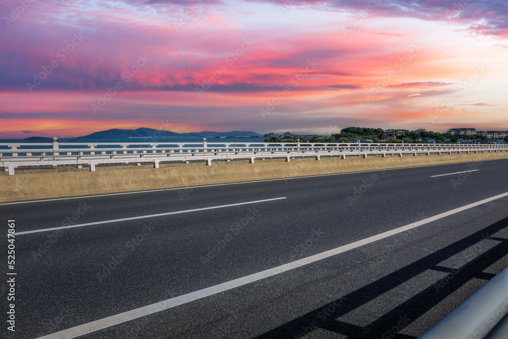 日落时分的沥青公路和美丽的海岸线自然景观