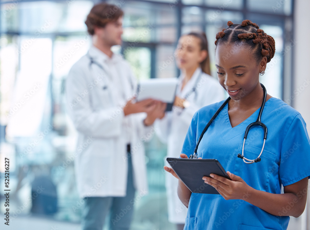 Female nurse or doctor browsing on a tablet for patient diagnosis or treatment on a medical or mobil