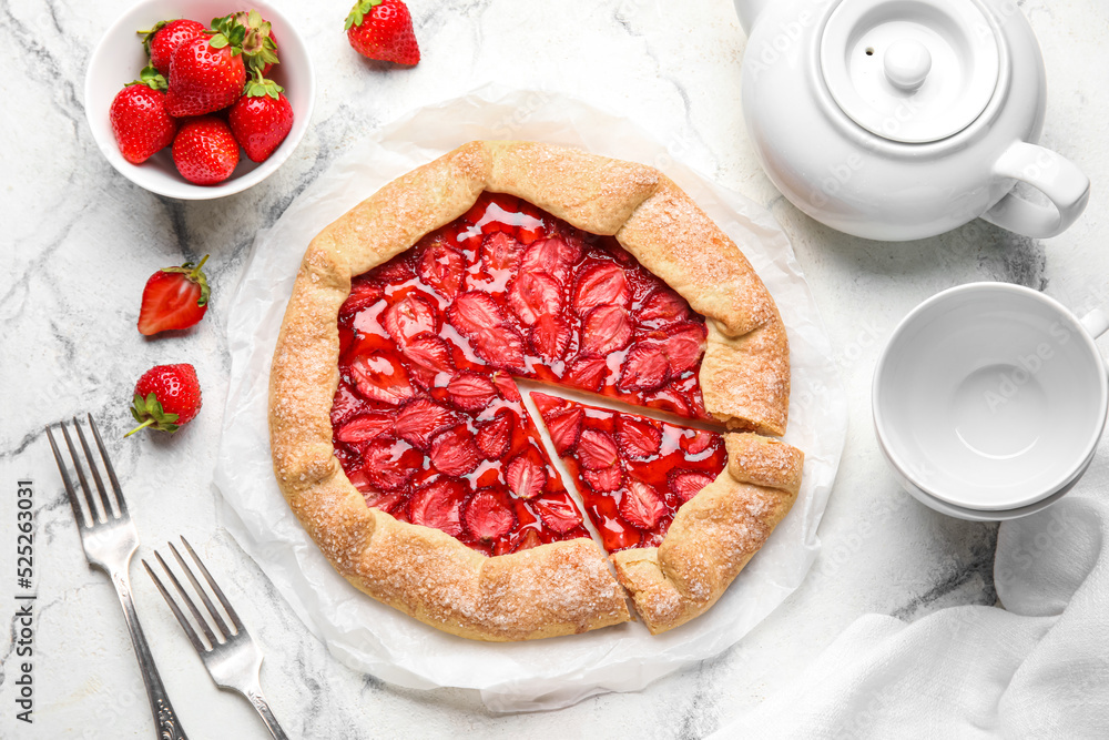 Sweet strawberry galette and fresh berries on light background