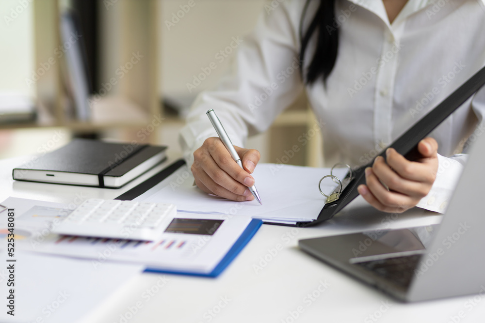 The secretary is writing the memo of the working message in the file.