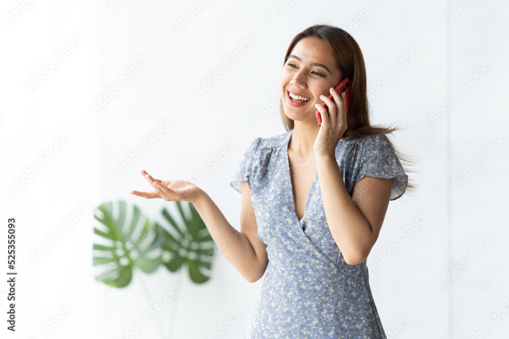 Asian businesswoman in formal suit in office happy and cheerful during using smartphone and working.