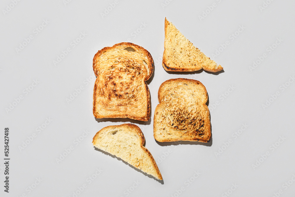 Slices of toasted bread on light background