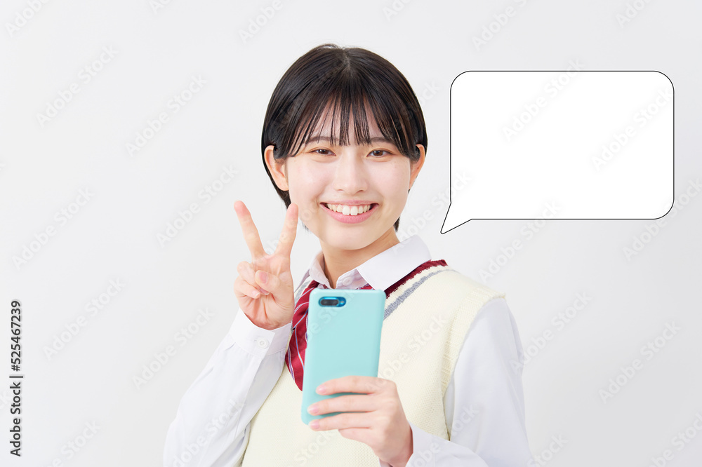 白背景でスマホを持ってピースサインする女子高生　吹き出しあり