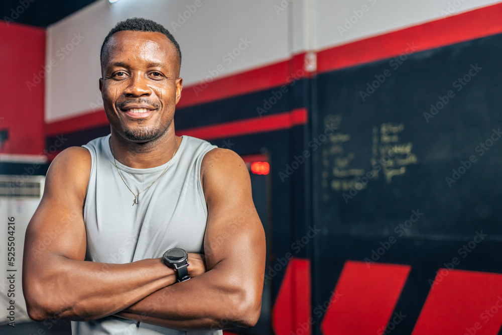 Portrait of young African American sportsman exercise in fitness gym.  