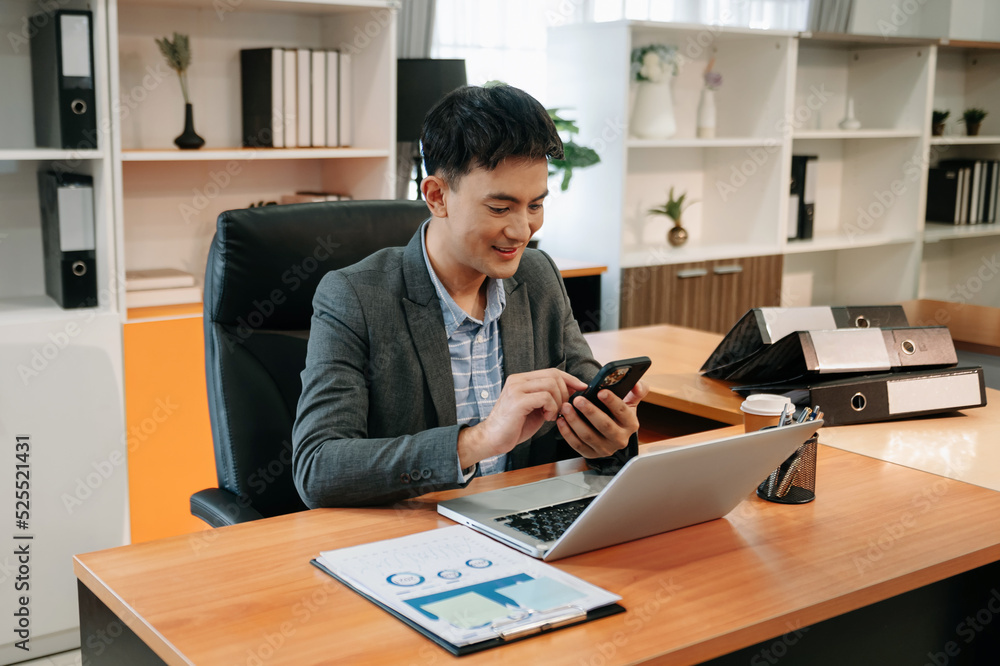  Young businessman Account Manager Working at Table with New Business Project. Typing smartphone ,Us