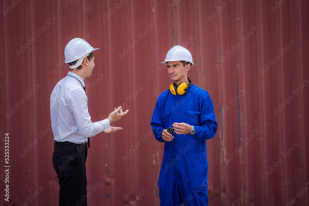 Businessman and worker planning the transportation for import or export in the container yard wareho