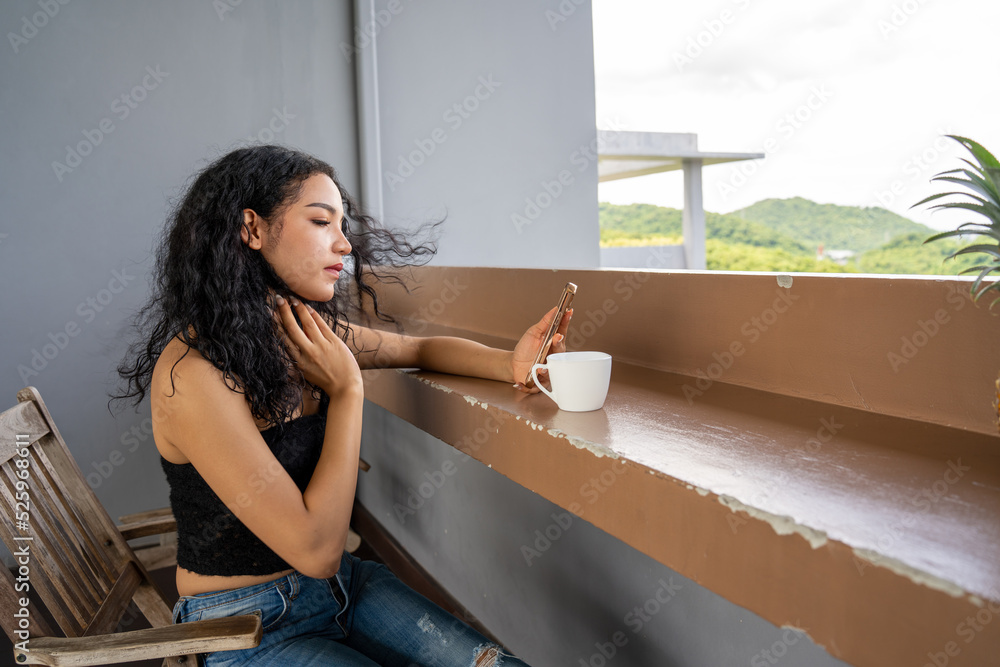 Young woman drinking a cup of coffee with a happy face standing and smiling with a confident smile. 