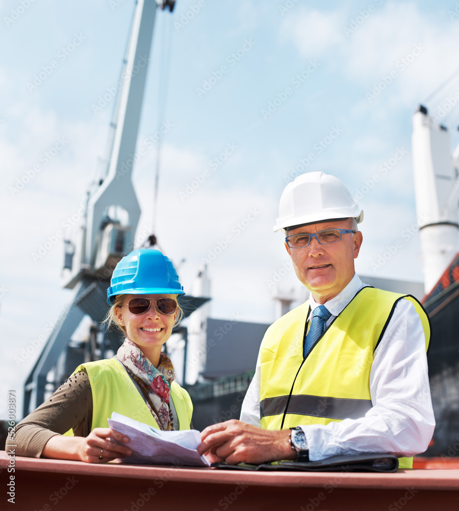 Ship engineer team planning in a meeting on the dock talking about paper work, cargo and shipping. P