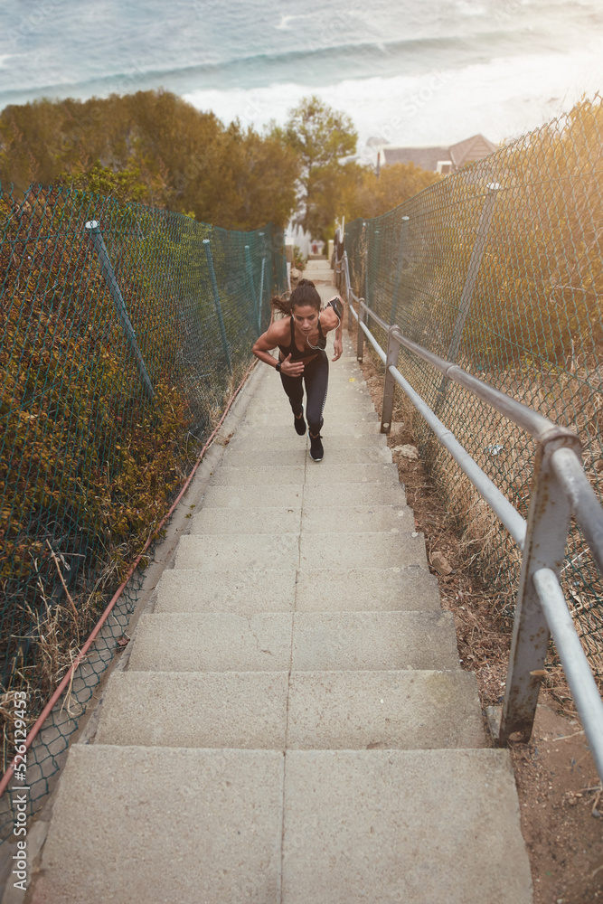 Fit young woman running up the stairs