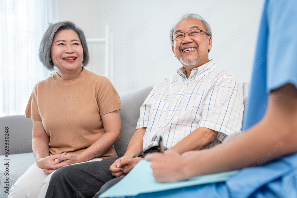 女医生在家里看望一对心满意足的老年夫妇。医疗保健，老年健康支持