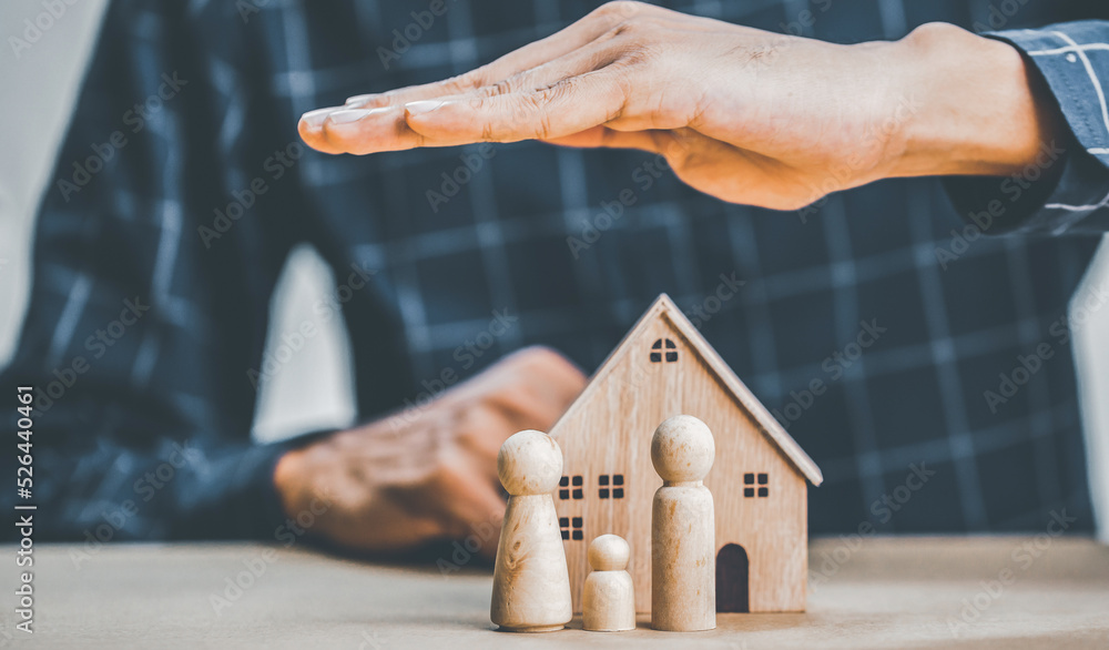 Insurance agent complete wooden model of the house with last pie