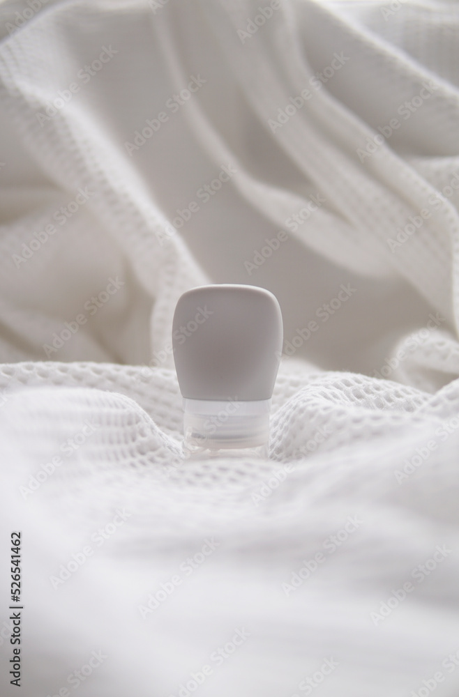 lotion tube mockup isolated on white fabric background.