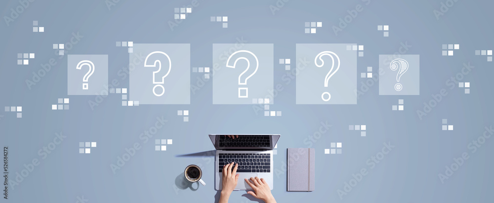 Question marks with person working with a laptop