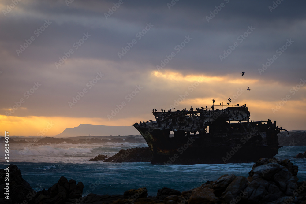 The sun sets beneath a dramatic sky at the wreck of the Meisho Maru No. 38 on the beautiful Cape Agu