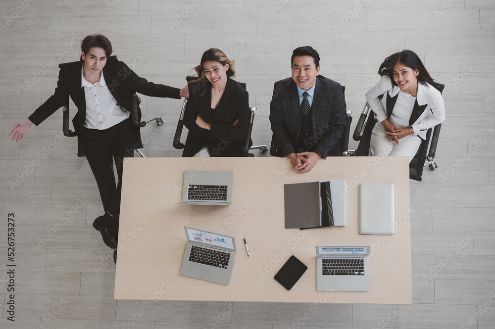 Aerial view of business people sitting at a desk during an office meeting. Show together. Unified co