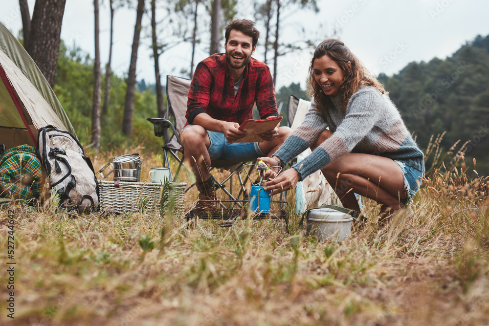 Happy young couple camping in nature