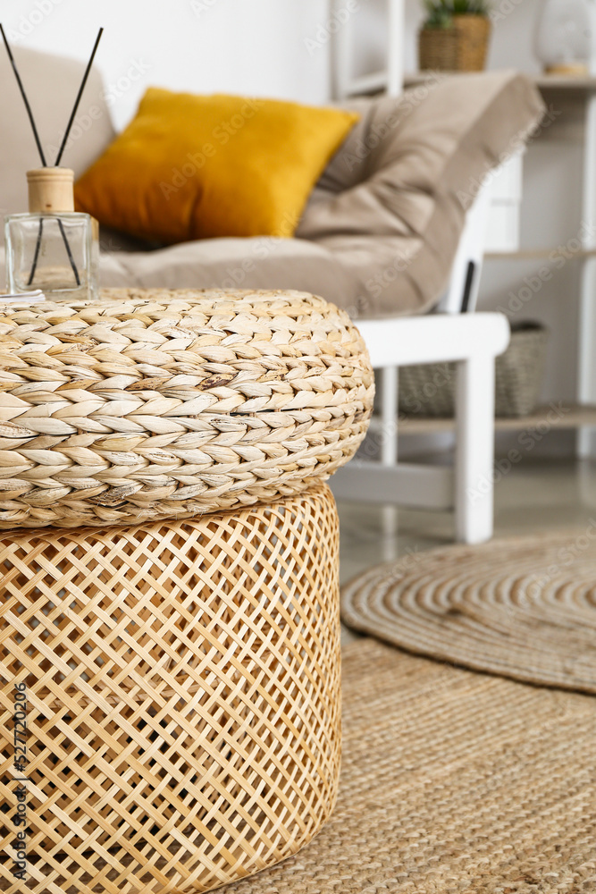 Rattan poufs with reed diffuser in living room, closeup