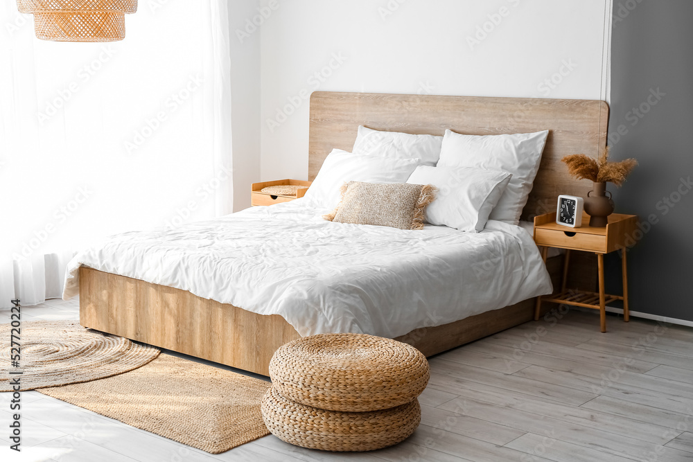 Interior of cozy bedroom with rattan poufs