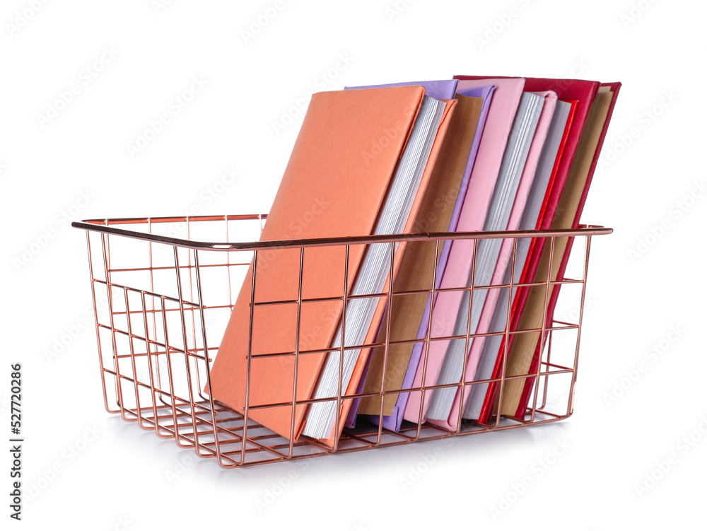 Pink metal basket with books on white background