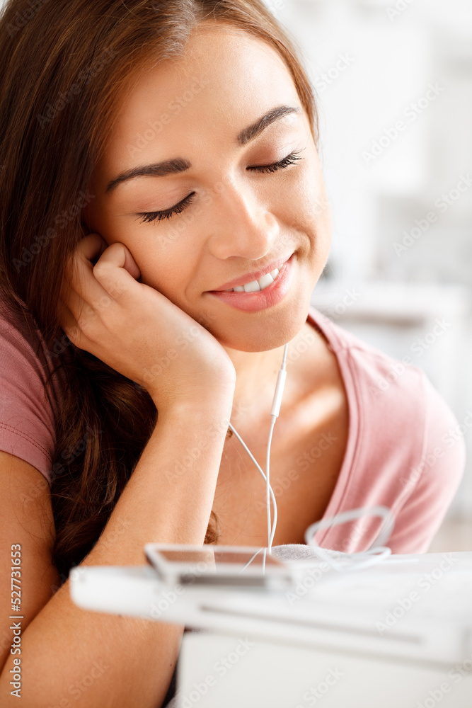 Happy woman listening to music on smartphone, streaming audio podcast and mobile app headphone techn