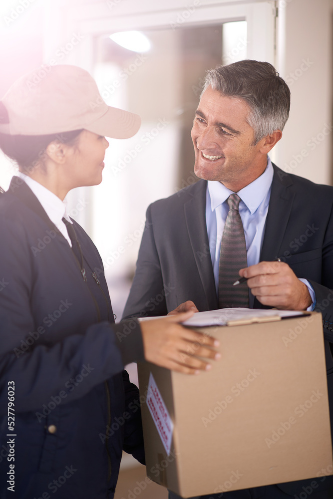 I wasnt expecting it so soon. Shot of a courier making a delivery to a smiling customer.