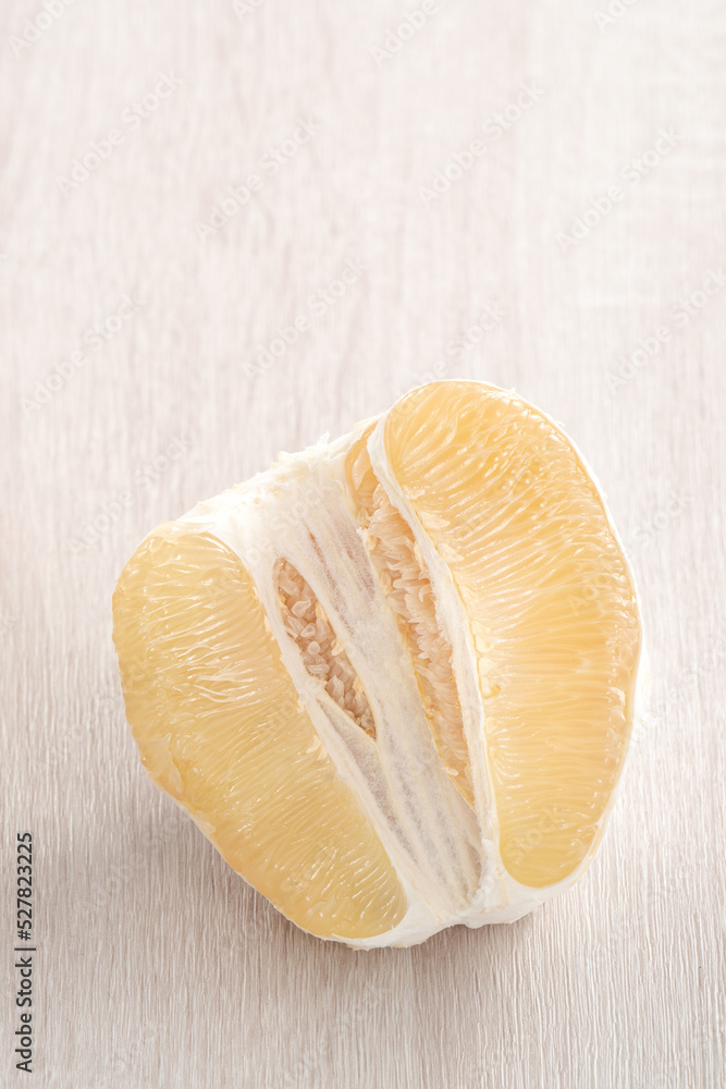 Fresh pomelo fruit on wooden table background.