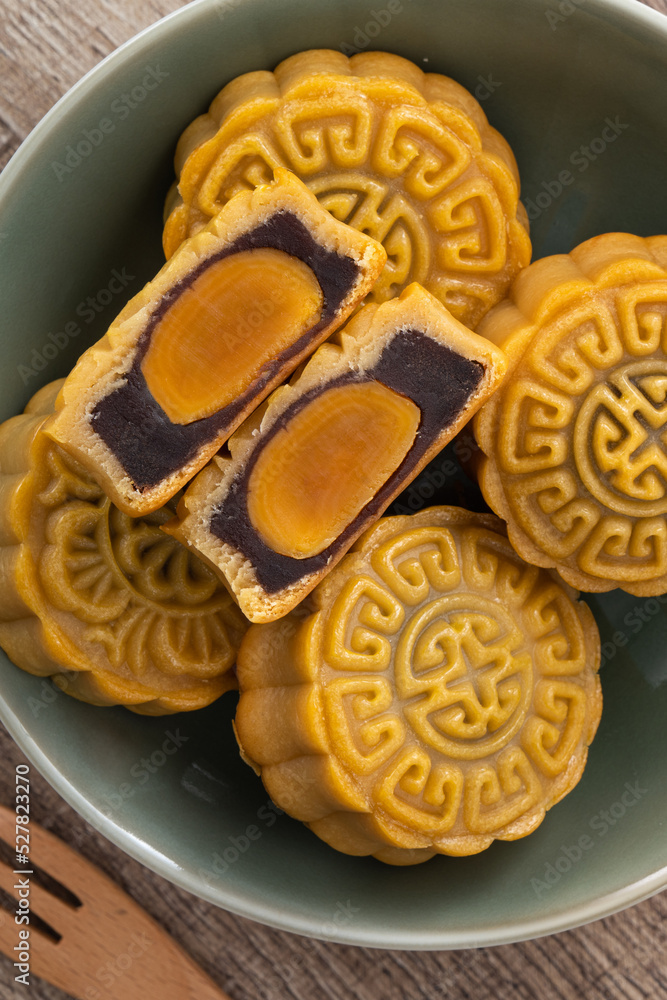 Delicious Cantonese moon cake for Mid-Autumn Festival food mooncake on wooden table background.