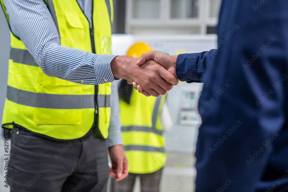 After concluding the meeting, competent investor shakes hands with engineer. Concept of the agreemen