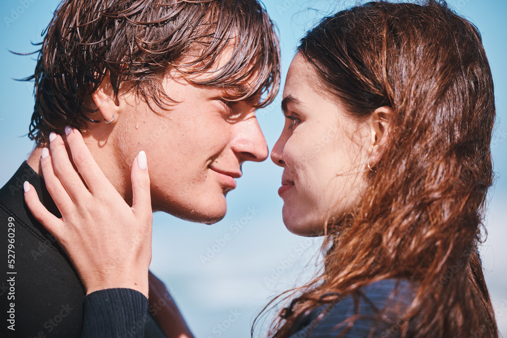 Young couple hug and sharing an intimate moment at the beach together, happy and carefree. Young boy